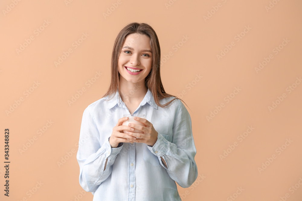 Young woman with tasty yogurt on color background Young woman with tasty yogurt on color background