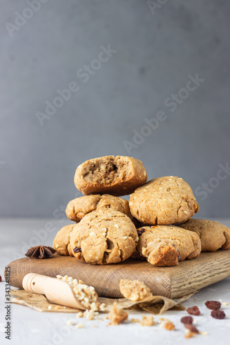 Homemade vegan cookies with buckwheat, raisin and nuts. Healthy sweet snack. Light grey stone background