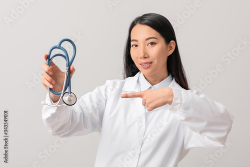 Female Asian doctor with st...