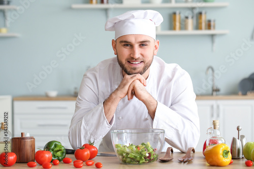 Handsome male chef in kitchen