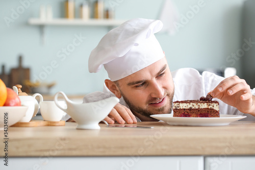 Handsome male chef with tas...