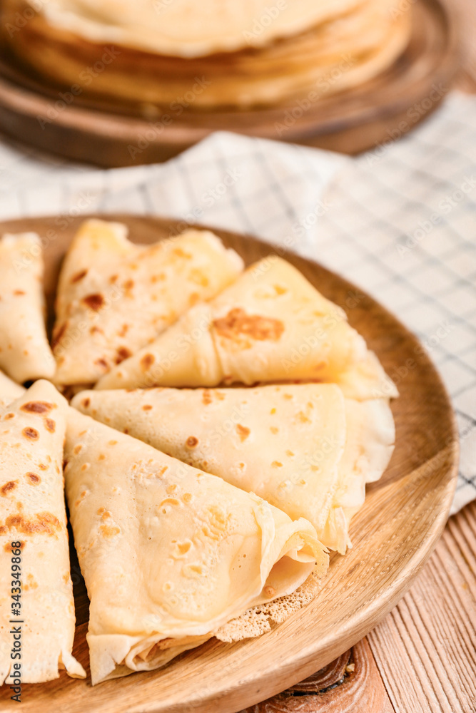 Plate with tasty blini on table, closeup