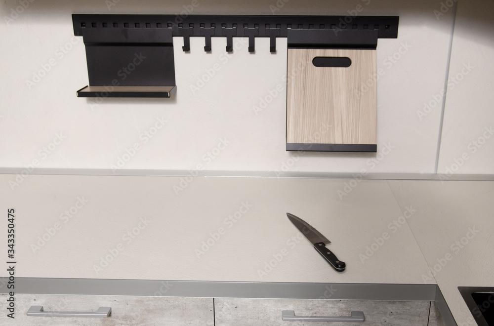 knife lies on a light countertop in a modern Scandinavian-style kitchen knife lies on a light countertop in a modern Scandinavian-style kitchen