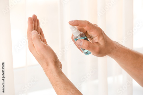 Man using sanitizer at home