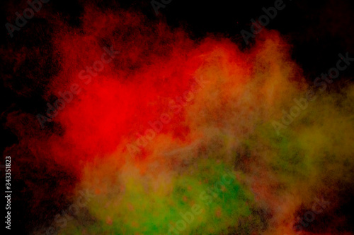 Colorful powder explosion on black background. Colorful dust explode. Paint Holi. © Nat PhotO