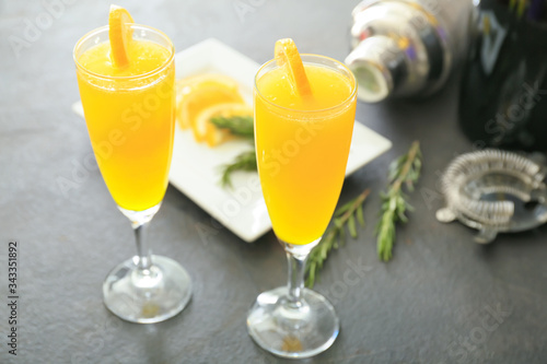 Glasses of tasty mimosa cocktails on table