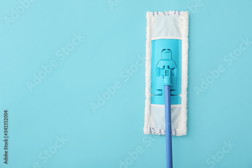 Floor mop on color background photo