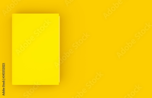 Single yellow hardcover book template mock-up on yellow background flat lay top view from above, modern minimal concept with copy space