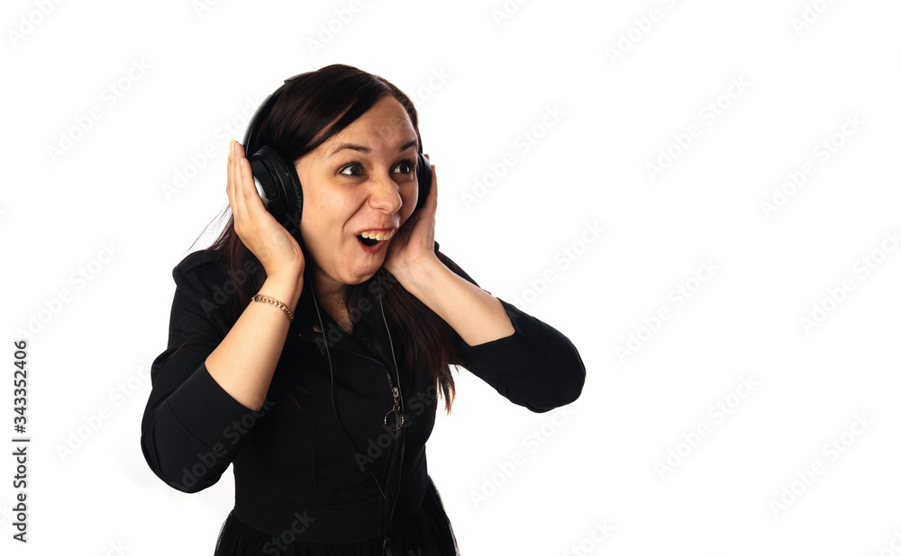 Crazy young woman in headphones isolated on a white background. Concept of the international day of music. Crazy young woman in headphones isolated on a white background. Concept of the international day of music.