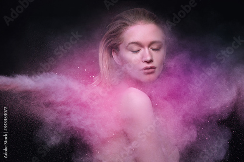 Makeup. Beautiful Sexy Young Woman Covered In Colored Cloud Of Cosmetic Pink Blush Powder. Glamorous Female Model With Flying Beauty Dust Products On Face And Body. High Resolution