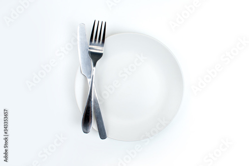A spoon and fork on a white plate