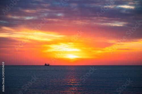 Cargo ship with containers in sunrise light © ValentinValkov