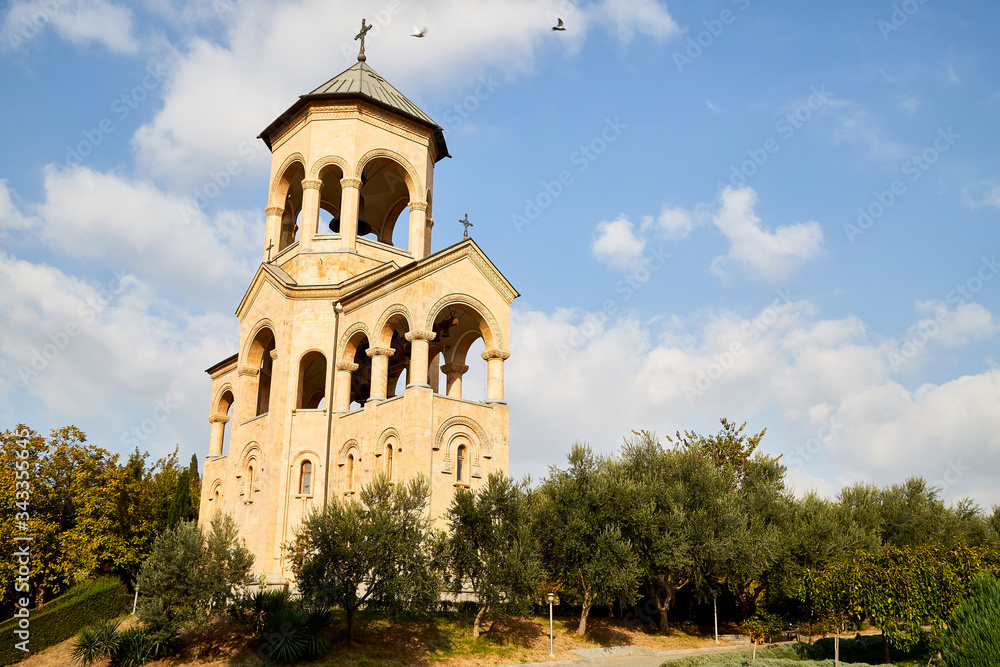 Big orthodox cathedral St. Trinity or Chirch Sameba in Tbilisi city in Georgia and blue sky background Big orthodox cathedral St. Trinity or Chirch Sameba in Tbilisi city in Georgia and blue sky background
