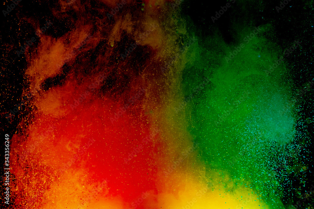 Fototapeta premium Abstract art powder paint on black background. Movement abstract frozen dust explosion multicolored on black background.