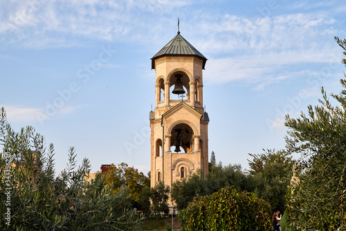 Big orthodox cathedral St. Trinity or Chirch Sameba in Tbilisi city in Georgia and blue sky background photo