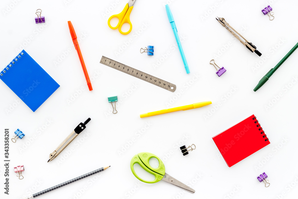 Flat lay stationery set - notebook, pen, sciccors - on white background top view Flat lay stationery set - notebook, pen, sciccors - on white background top view