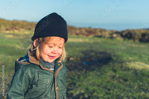 Preschooler playing on the moor in spring