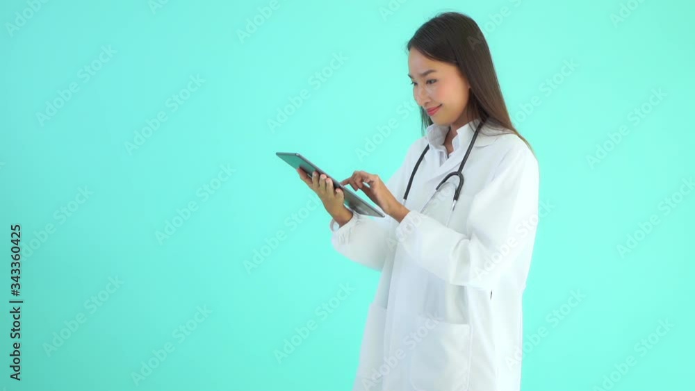 Asian lady doctor using a tablet with joy Asian lady doctor using a tablet with joy