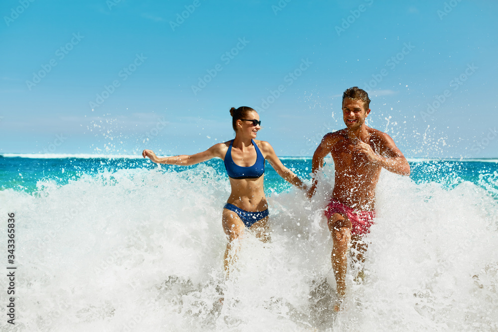 Couple Fun On Beach. Romantic People In Love Running On Sand At Luxury Sea Resort. Handsome Happy Man, Beautiful Smiling Woman Laughing Together On Summer Travel Vacation. Relationships, Summertime Couple Fun On Beach. Romantic People In Love Running On Sand At Luxury Sea Resort. Handsome Happy Man, Beautiful Smiling Woman Laughing Together On Summer Travel Vacation. Relationships, Summertime