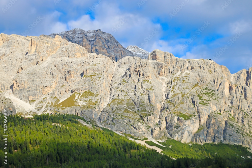 Beautiful Dolomites in Italy. Clear day with blue sky. Mountains are illuminated by the rays of the sun. Clean fresh air. Selective focus.