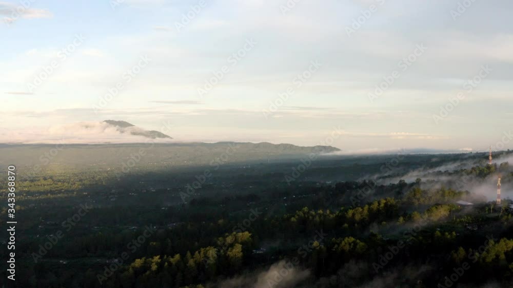 Besakih town at the foot of Mount Batur in Bali Indonesia on a foggy morning, Aerial dolly right shot Besakih town at the foot of Mount Batur in Bali Indonesia on a foggy morning, Aerial dolly right shot