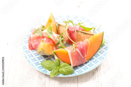 melon slices with prosciutto ham and basil