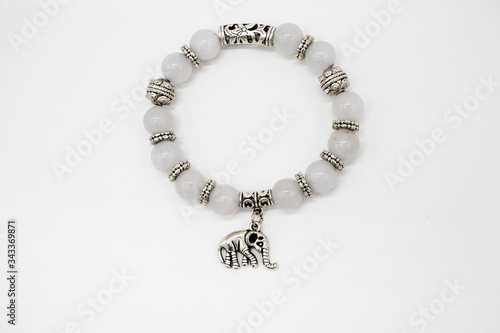 Hand bracelet with pearls and an elephant figurine isolated on a white background