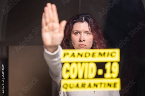 Woman showing stop gesture. Girl show stop palm. Stop coronavirus or covid-19 and the pandemic. Stay home. Quarantine concept.