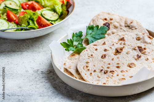 Homemade indian flatbread chapati on a gray background. Vegetarian cuisine concept.