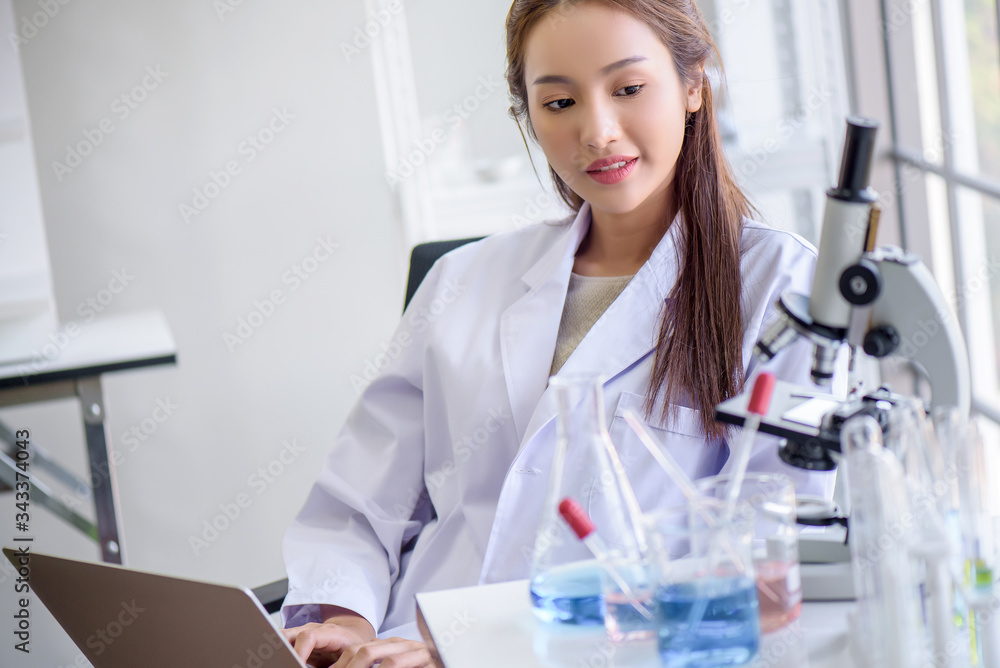 Attractive young Asian scientist woman lab technician assistant analyzing sample in test tube with microscope at laboratory. Medical, pharmaceutical and scientific research and development concept. Attractive young Asian scientist woman lab technician assistant analyzing sample in test tube with microscope at laboratory. Medical, pharmaceutical and scientific research and development concept.