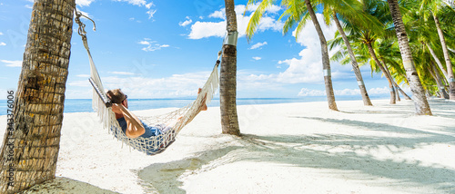 Man in hammock on the beautiful tropical beach. Banner.