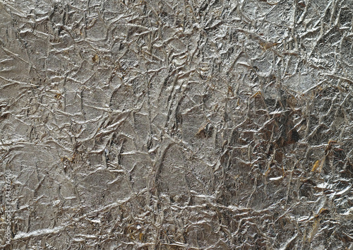 Bronze wrinkled paper texture abstract background. Antique bronze jammed foil texture, handmade crumpled texture.