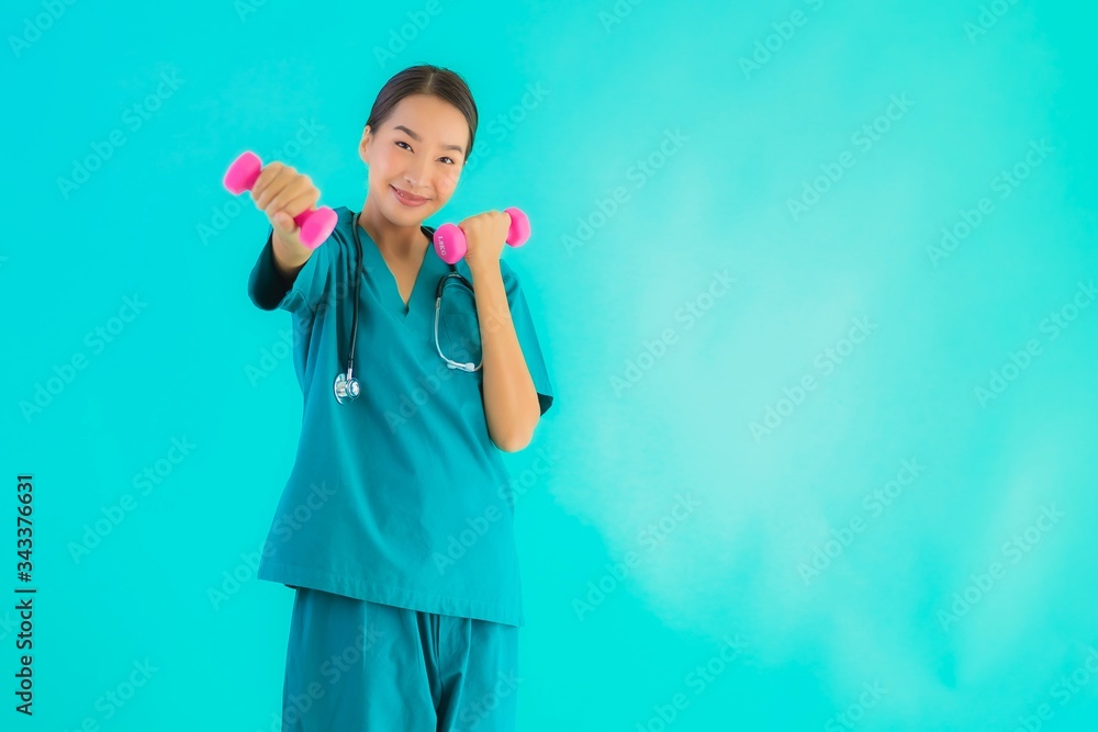 Portrait beautiful young asian doctor woman exercise with dumbbell Portrait beautiful young asian doctor woman exercise with dumbbell