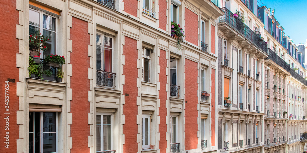 Paris, beautiful building in Montmartre, with typical orange brick on the facade
