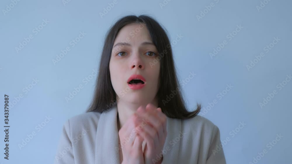 Woman coughs on white background during coronavirus pandemic quarantine, front view. Fighting with covid-19 epidemic. Sick young girl with flu, sars with the symptom of coughing.