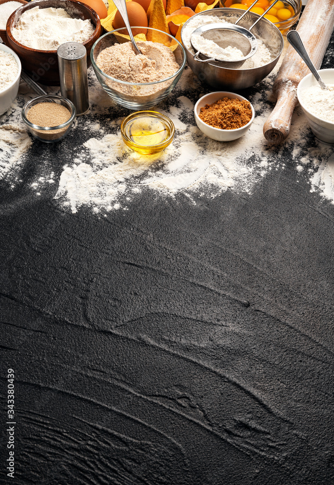 Baking ingredients on black background with copy space Baking ingredients on black background with copy space