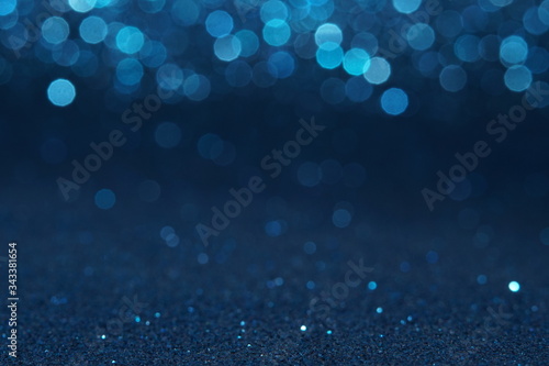 blue Sparkling Lights Festive background with texture. Abstract Christmas twinkled bright bokeh defocused and Falling stars. Winter Card or invitation	