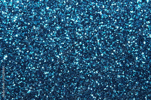 blue Sparkling Lights Festive background with texture. Abstract Christmas twinkled bright bokeh defocused and Falling stars. Winter Card or invitation 