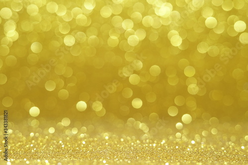 gold Sparkling Lights Festive background with texture. Abstract Christmas twinkled bright bokeh defocused and Falling stars. Winter Card or invitation 