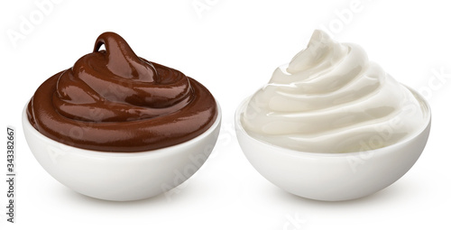 Bowl of chocolate and milk vanilla cream isolated on white background photo