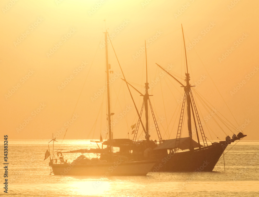 Golden sunset with boat in the sea  background