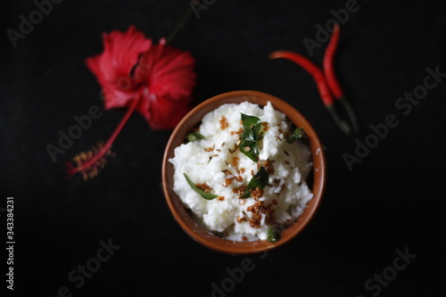 Curd rice-dahi bhat (yogurt rice) traditional food of india  which is tempered with curry leaves ,mustard seeds and urad dal in a bowl. photo