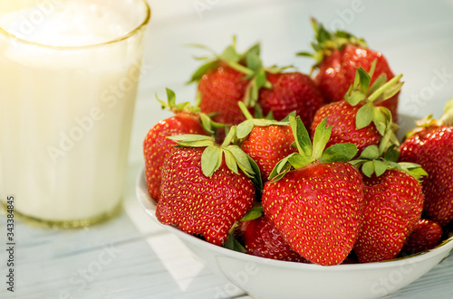 Ripe strawberries and a glass of milk. natural farm products. 