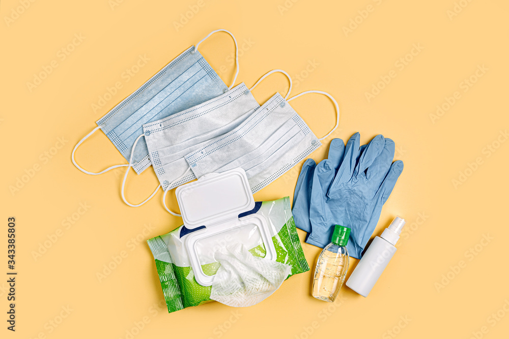 Fotka „White medical masks and gloves with antibacterial wet wipes and hand  sanitizer on yellow background. Personal hygiene product for protection  virus, flu, coronavirus, COVID-19“ ze služby Stock | Adobe Stock