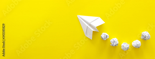 education or innovation concept. paper origami plane over yellow background photo