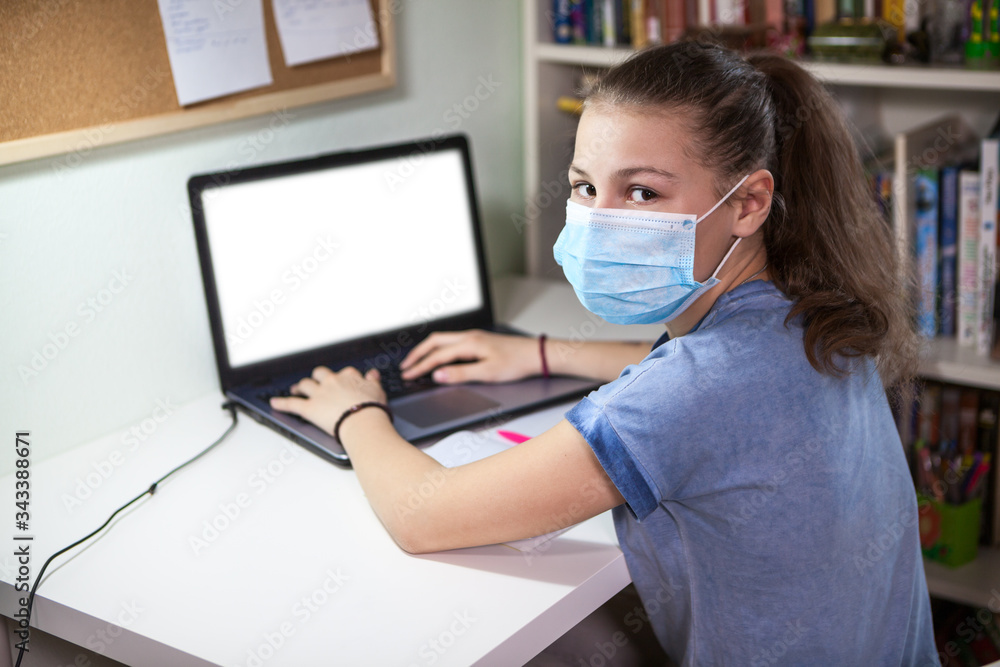 Girl wearing facial mask searching information on internet for distance studying, typing Girl wearing facial mask searching information on internet for distance studying, typing