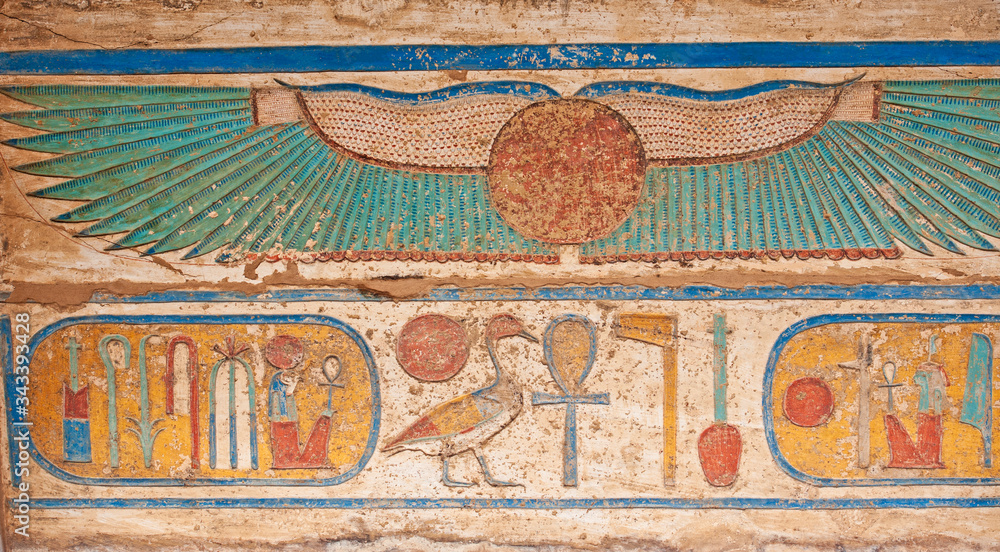 Hieroglyphic carving painting on an ancient egyptian temple wall