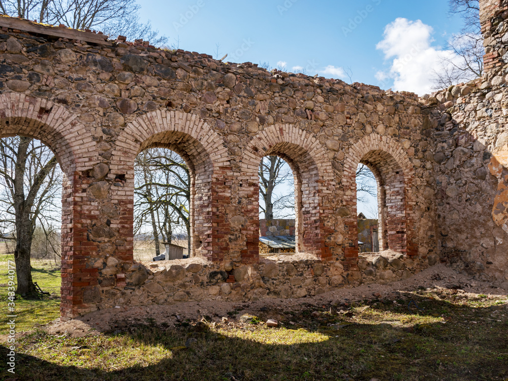 landscape with beautiful abandoned church ruins, arched windows, stone walls, building without a roof