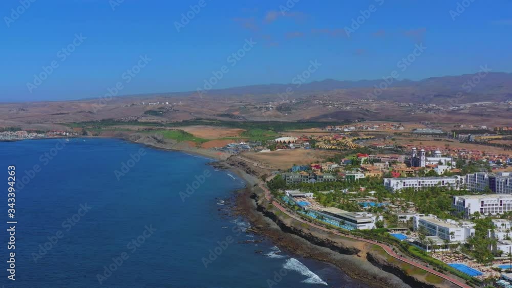 Aerial view of the north coast, Gran Canaria, Canary islands, Spain, Europe. Wide drone view with mountains in the distance, sea, palms, seashore. Aerial view of the north coast, Gran Canaria, Canary islands, Spain, Europe. Wide drone view with mountains in the distance, sea, palms, seashore.