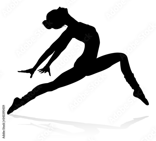 Ballet dancer woman in silhouette dancing in posed position